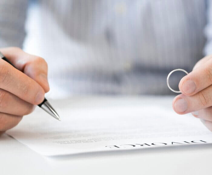 man-with-marriage-ring-divorce-contract